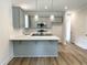 Lovely kitchen features breakfast bar, gray cabinets, and stainless appliances at 1448C Maplewood Dr, Durham, NC 27704