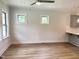 Bright living space with wood floors, neutral walls, and a view to the kitchen at 1448C Maplewood Dr, Durham, NC 27704