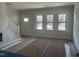 Spacious living room featuring three large windows that offer abundant natural light at 1448C Maplewood Dr, Durham, NC 27704