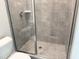 Glass shower features modern fixtures and neutral tiling at 1448C Maplewood Dr, Durham, NC 27704