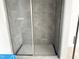 Modern bathroom featuring new shower with gray tiling and glass door at 1448C Maplewood Dr, Durham, NC 27704