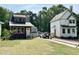 Street view of three homes with craftsman trim, metal roofs and neatly manicured lawns at 1448C Maplewood Dr, Durham, NC 27704