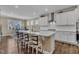 Modern kitchen island with seating for four, stainless steel appliances, and ample cabinet space at 163 Auburn Village Blvd, Raleigh, NC 27610