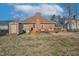 View of the backyard, wooden deck, brick chimney, shed, and patio, offering an inviting outdoor living space at 1709 Shamrock Ln, Rocky Mount, NC 27804