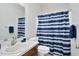 Cozy bathroom with blue and white striped shower curtain, vanity and mirror at 1709 Shamrock Ln, Rocky Mount, NC 27804