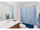Bathroom featuring a shower and tub combo with a blue shower curtain and single sink vanity at 1709 Shamrock Ln, Rocky Mount, NC 27804