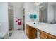A traditional bathroom featuring wallpaper, a large mirror, and a combined shower and bathtub at 1709 Shamrock Ln, Rocky Mount, NC 27804