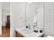 Cozy bathroom featuring a vanity, white countertop, and floral wallpaper at 1709 Shamrock Ln, Rocky Mount, NC 27804