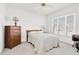 Bright bedroom featuring neutral carpet, white walls, dresser, and large window at 1709 Shamrock Ln, Rocky Mount, NC 27804