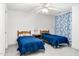 Cozy bedroom featuring two twin beds, a ceiling fan, and bright white walls at 1709 Shamrock Ln, Rocky Mount, NC 27804