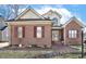 Charming brick home featuring burgundy shutters and a manicured front yard landscape at 1709 Shamrock Ln, Rocky Mount, NC 27804