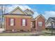 Charming brick home with burgundy shutters and manicured yard, with car parked on the side at 1709 Shamrock Ln, Rocky Mount, NC 27804