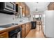 Kitchen with wood cabinetry and backsplash, cooktop, oven, microwave, and dining area at 1709 Shamrock Ln, Rocky Mount, NC 27804