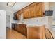 Charming kitchen featuring wood cabinets, floral wallpaper, and functional appliances at 1709 Shamrock Ln, Rocky Mount, NC 27804