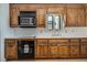 Kitchen featuring wood cabinets, backsplash, cooktop and oven appliance, and breakfast bar at 1709 Shamrock Ln, Rocky Mount, NC 27804