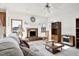 Cozy living room with a brick fireplace, ceiling fan, and glass topped coffee table at 1709 Shamrock Ln, Rocky Mount, NC 27804