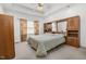 This main bedroom features a ceiling fan, wall-to-wall carpeting, and an integrated headboard and cabinets at 1709 Shamrock Ln, Rocky Mount, NC 27804