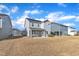 View of a home's backyard with an attached covered patio, perfect for outdoor entertainment at 1776 Golden Honey Dr, Wake Forest, NC 27587