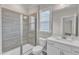Bathroom featuring a glass enclosed shower, white vanity, and a window at 1776 Golden Honey Dr, Wake Forest, NC 27587