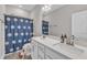 Bathroom features a double sink vanity with granite countertop and a shower-tub combo at 1776 Golden Honey Dr, Wake Forest, NC 27587