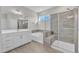 Luxurious bathroom featuring a soaking tub and a separate glass-enclosed shower with tiled walls at 1776 Golden Honey Dr, Wake Forest, NC 27587