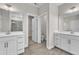 Well-lit bathroom featuring dual vanities, modern fixtures, and tile flooring at 1776 Golden Honey Dr, Wake Forest, NC 27587