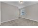 This is a carpeted bedroom with a neutral color scheme and a window offering natural light at 1776 Golden Honey Dr, Wake Forest, NC 27587