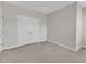 This carpeted bedroom has neutral walls, base molding, and a closet with bifold doors at 1776 Golden Honey Dr, Wake Forest, NC 27587