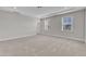 Bedroom with a tray ceiling, neutral walls, carpeted floor and two windows at 1776 Golden Honey Dr, Wake Forest, NC 27587