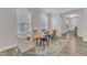 Bright dining room boasts hardwood floors, neutral walls, and sunlit windows at 1776 Golden Honey Dr, Wake Forest, NC 27587