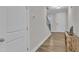 Light and airy entryway with hardwood floors, leading to staircase and front door at 1776 Golden Honey Dr, Wake Forest, NC 27587