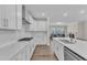 Modern kitchen with white cabinets, countertops, stainless appliances, and gas range at 1776 Golden Honey Dr, Wake Forest, NC 27587