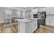 Spacious kitchen with large island, stainless appliances, and seamless flow into the dining area at 1776 Golden Honey Dr, Wake Forest, NC 27587