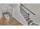 Elegant staircase with black iron railing leading to the upper level of the home at 1776 Golden Honey Dr, Wake Forest, NC 27587