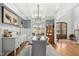 Elegant dining room with coffered ceilings, a modern light fixture, and wainscoting at 185 Bella Vita Dr, Clayton, NC 27527