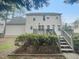 Two-story home featuring a backyard deck and stairs, perfect for outdoor relaxation and entertainment at 1908 Mystic Dr, Durham, NC 27712