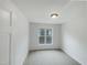 Bright bedroom features neutral carpet, ample natural light from the window, and fresh paint at 1908 Mystic Dr, Durham, NC 27712