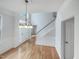 Grand foyer with hardwood floors, statement chandelier, staircase, and natural light at 1908 Mystic Dr, Durham, NC 27712