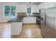 Modern kitchen featuring stainless steel appliances, granite countertops, and bright white cabinetry at 1908 Mystic Dr, Durham, NC 27712