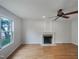 Bright living room featuring a fireplace, ceiling fan, and beautiful hardwood floors at 1908 Mystic Dr, Durham, NC 27712