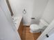 Cozy powder room features hardwood floors, a vanity, and a toilet at 1908 Mystic Dr, Durham, NC 27712