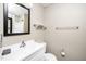 Neutral bathroom featuring a white vanity, framed mirror, and ceramic tile flooring at 2011 Quaker Lndg # 101, Raleigh, NC 27603