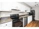 Kitchen with laminate countertops and a suite of black appliances at 2011 Quaker Lndg # 101, Raleigh, NC 27603