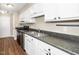 Kitchen featuring a double sink, black countertops, and black appliances at 2011 Quaker Lndg # 101, Raleigh, NC 27603