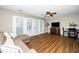 Comfortable living room featuring wood flooring, a ceiling fan, and sliding glass doors at 2011 Quaker Lndg # 101, Raleigh, NC 27603