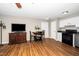 Open-concept space with wood floors, TV, dining area, and access to the kitchen at 2011 Quaker Lndg # 101, Raleigh, NC 27603