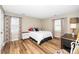 Main bedroom with hardwood floors, colorful curtains, and lots of natural light at 2011 Quaker Lndg # 101, Raleigh, NC 27603