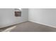 An empty bedroom featuring neutral walls and flooring, complemented by a window and base molding at 2105 Attend Xing, Fuquay Varina, NC 27526