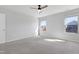 Bright bedroom featuring a ceiling fan, neutral walls, and a pair of windows at 2105 Attend Xing, Fuquay Varina, NC 27526