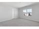 This bedroom features neutral paint, carpet, and a window with backyard views at 2105 Attend Xing, Fuquay Varina, NC 27526
